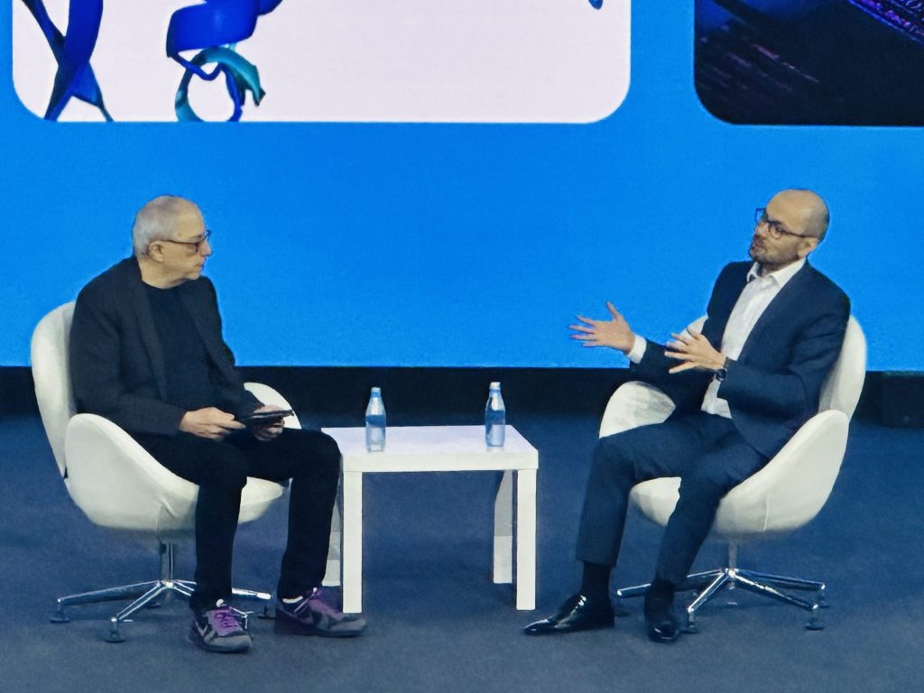 Demis Hassabis (right) speaks at Mobile World Congress in Barcelona.